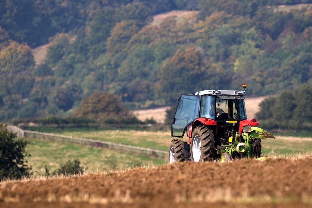 A tractor in the middle of a field.