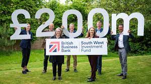 Photo of people in a garden holding up £200m with British Business Bank logo underneath